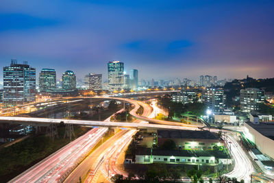 High angle view of illuminated city buildings at night