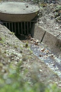 High angle view of water flowing through concrete wall
