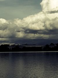 Scenic view of river against cloudy sky