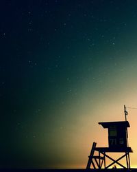 Low angle view of lifeguard hut against star field