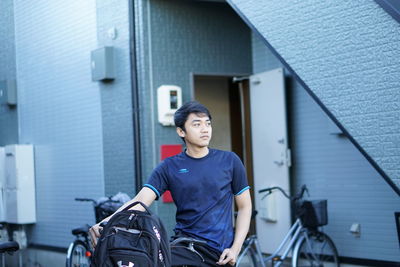 Portrait of young man sitting outdoors