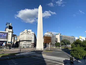 Buildings in city against blue sky