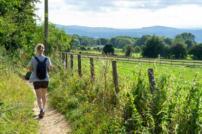 Woman hiking on the cotswold way in gloucestershire