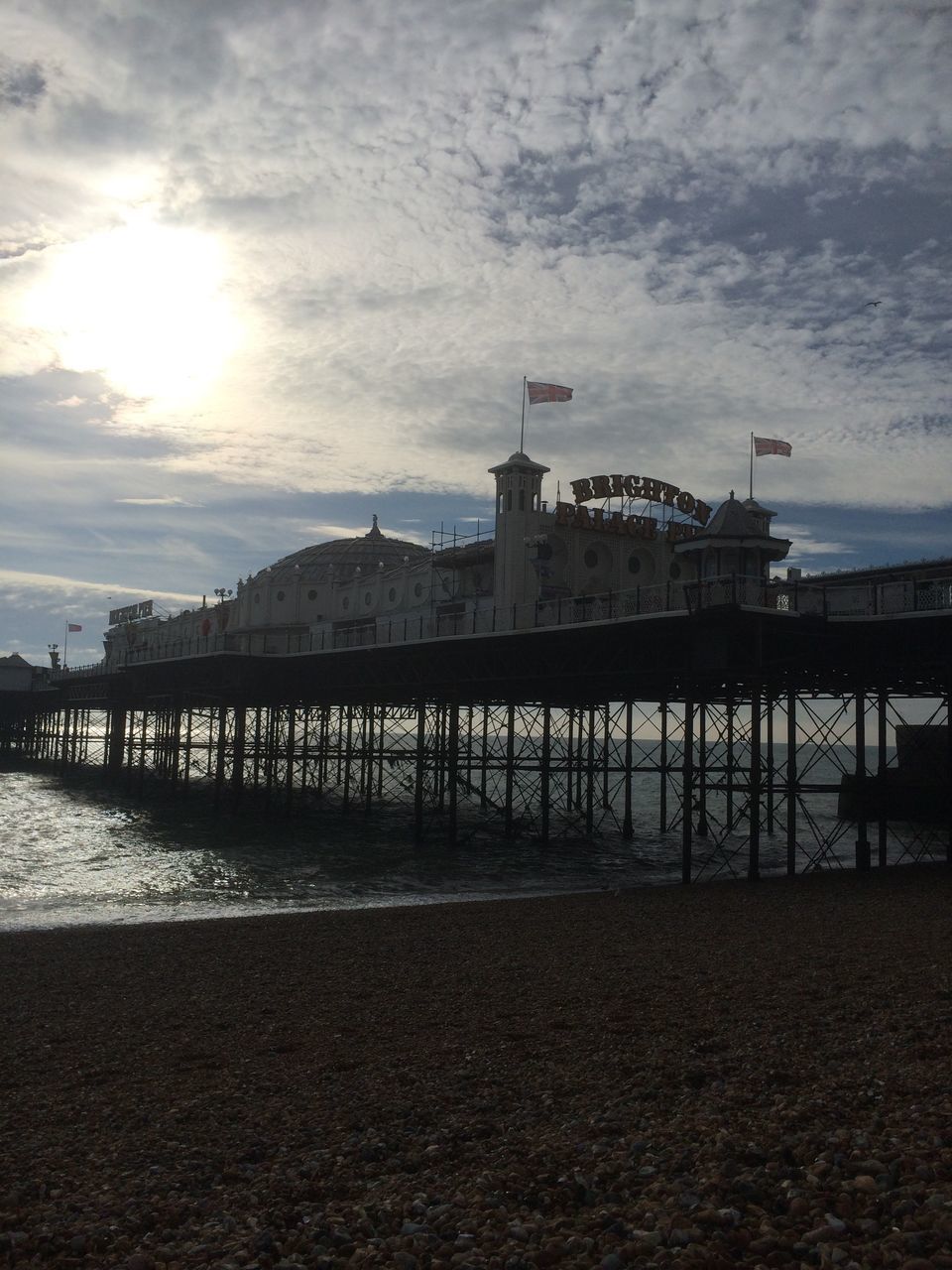 PIER ON BEACH AGAINST SKY