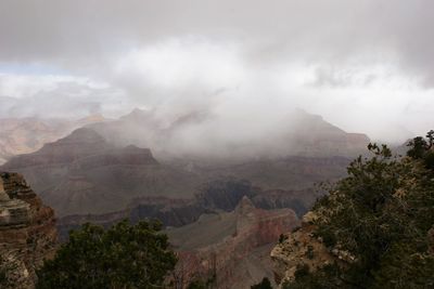 Scenic view of mountains against cloudy sky