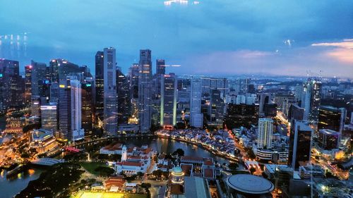 High angle view of illuminated city buildings against sky