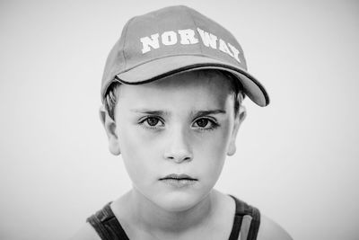 Close-up portrait of boy wearing cap