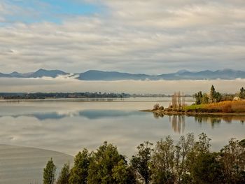 Scenic view of lake and mountains against sky