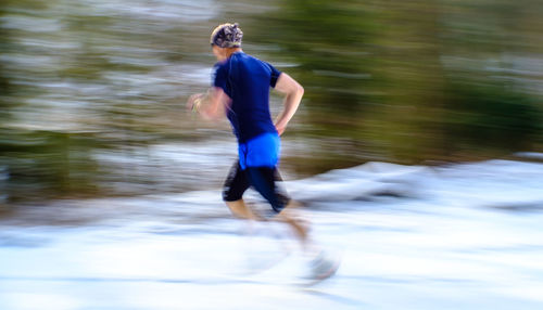 Full length of man running in water