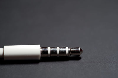 Close-up of machine on table against black background