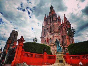 Low angle view of church against cloudy sky