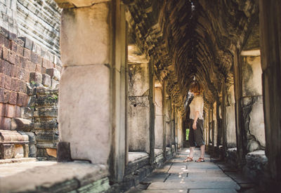 Woman standing in corridor of building