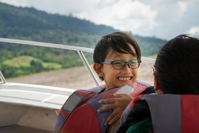 Girls wearing life jackets in boat