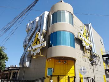 Low angle view of building against clear blue sky