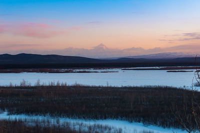 Scenic view of lake against sky during sunset