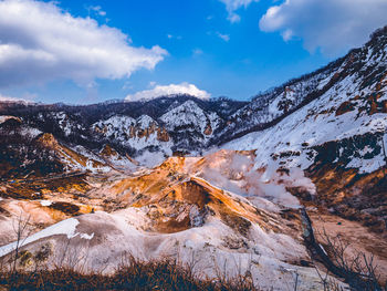 Scenic view of snowcapped mountains against sky