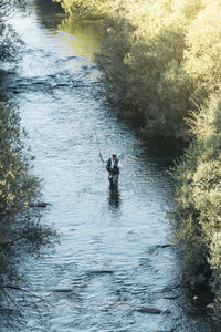 Full length of man standing in water outdoors