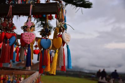 Close-up of decoration hanging on tree against sky