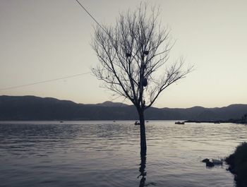 Scenic view of lake and mountains at sunset