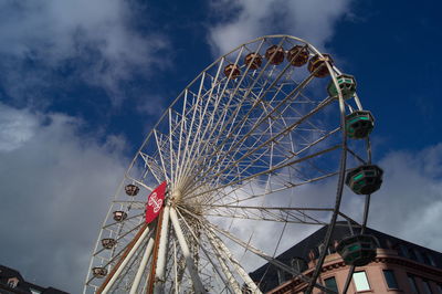 Low angle view of ferris wheel against sky