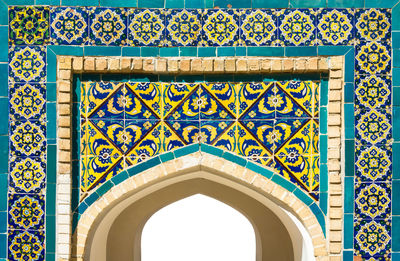 Low angle view of ornate building against blue sky