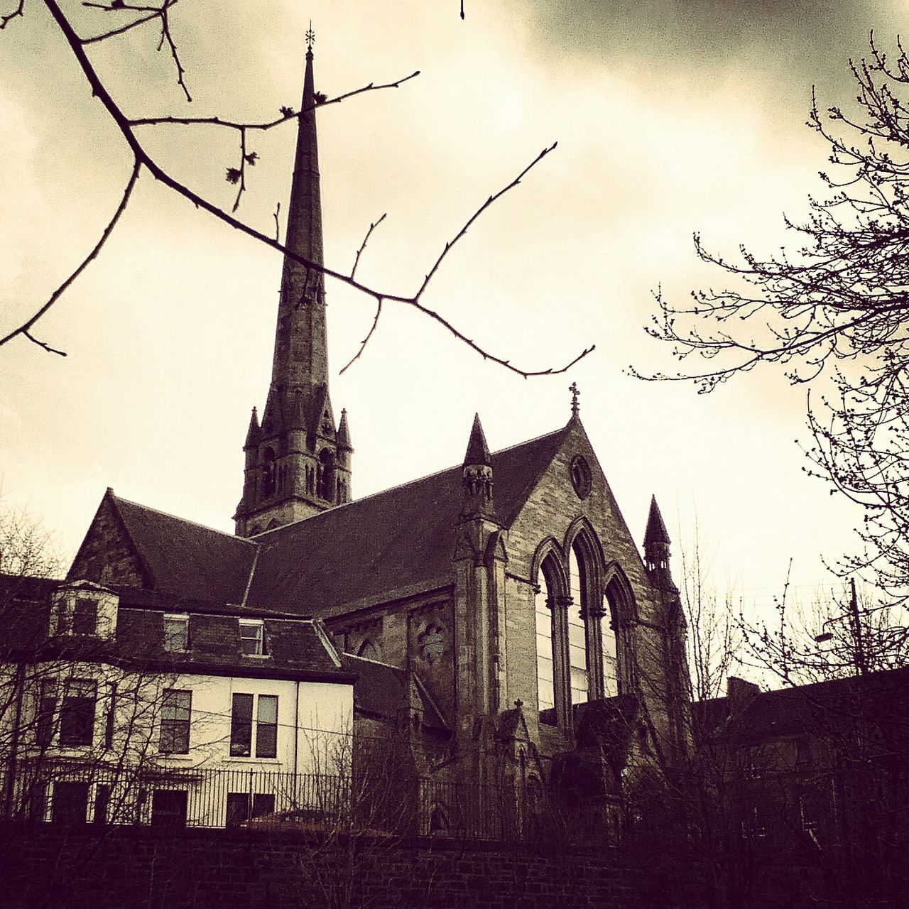 architecture, building exterior, built structure, church, place of worship, religion, spirituality, low angle view, sky, cathedral, old, history, cross, outdoors, steeple, cloud - sky, no people, day