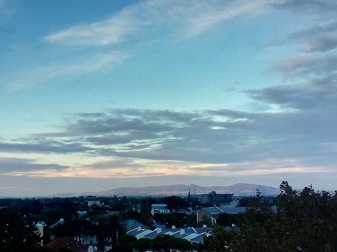 TOWN AGAINST SKY AT SUNSET