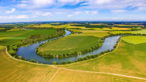 Scenic view of agricultural field against sky