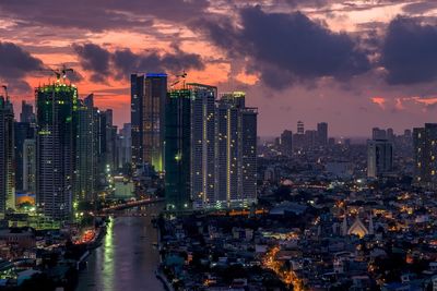 Aerial view of city lit up at sunset