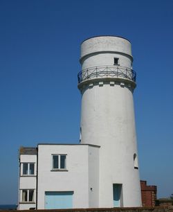 Low angle view of tower against blue sky