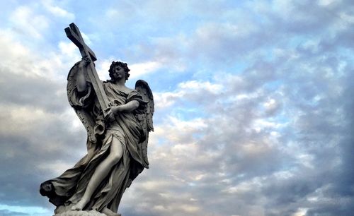 Low angle view of statue against cloudy sky