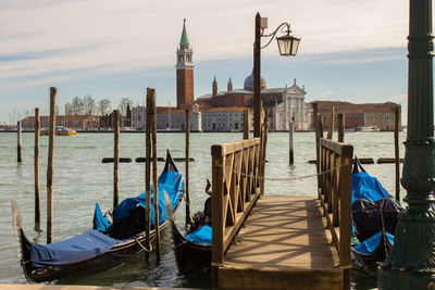 Gondolas moored on grand canal with church of san giorgio maggiore in background