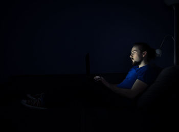Man using mobile phone at night