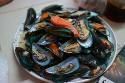 High angle view of shells in plate on table