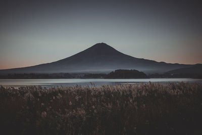 Scenic view of lake and mountains against clear sky