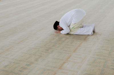 High angle view of man sitting on floor