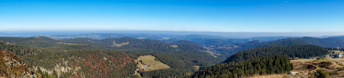 Scenic view of mountains against clear blue sky