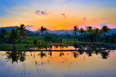 Scenic view of lake against sky during sunset