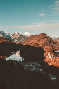 Scenic view of lake by mountains against sky