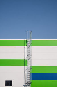 Low angle view of electricity pylon against clear sky