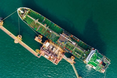 High angle view of shipping oil and gas loading terminal on green sea