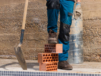 Low section of man standing in wicker basket