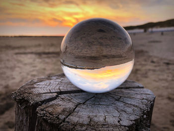 Close-up of crystal ball on wooden post