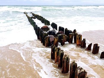 Wooden posts on beach