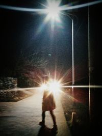 Sunlight falling on illuminated road at night