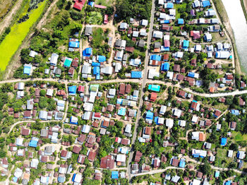 High angle view of trees and buildings in city