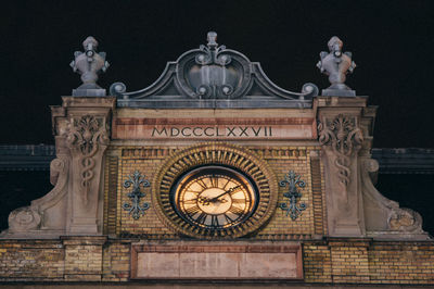 Clock with roman numbers and letters on a historic house