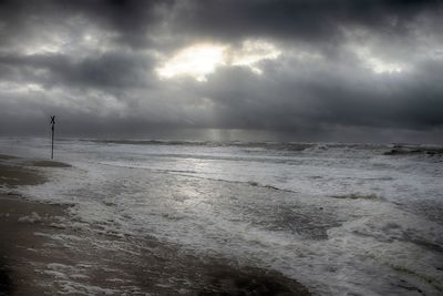 Scenic view of sea against storm clouds