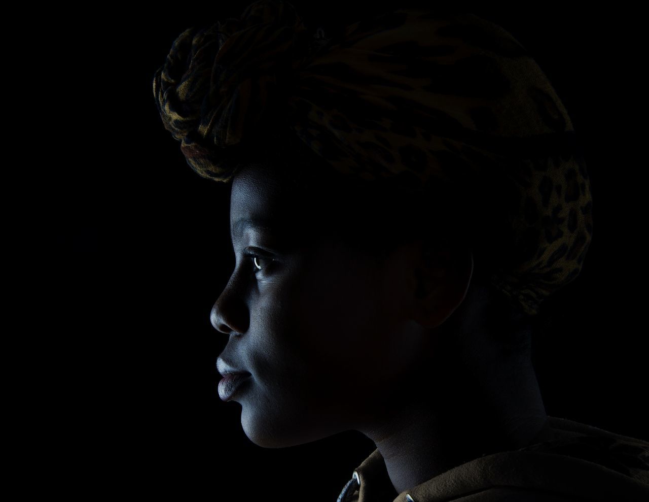 headshot, studio shot, portrait, one person, close-up, indoors, black background, looking, looking away, lifestyles, side view, contemplation, real people, cut out, young adult, child, serious, profile view, human face, dark, teenager