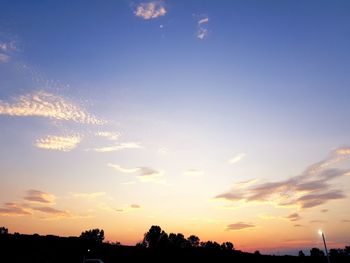 Low angle view of silhouette trees against sky during sunset